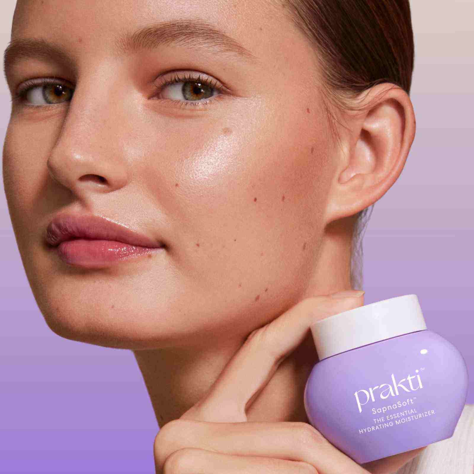 woman holding SapnaSoft weightless moisturizer jar with glowing smooth skin